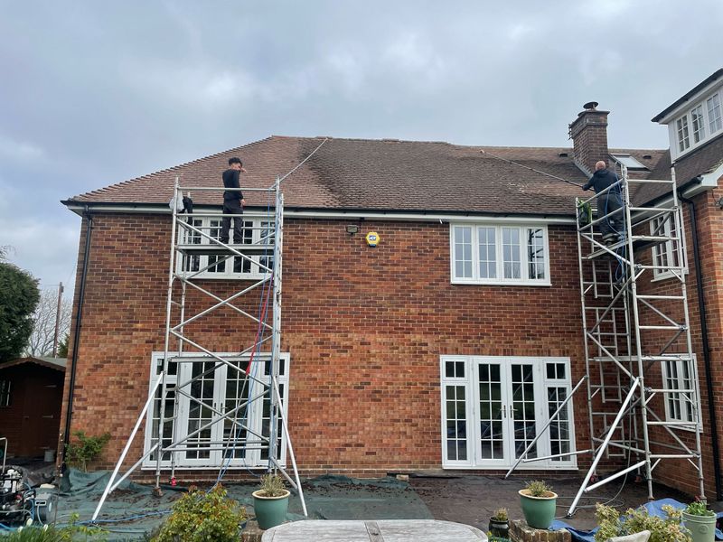 Roof cleaning carried out safely from scaffold towers by The Roof Moss Cleaners in Thrapston